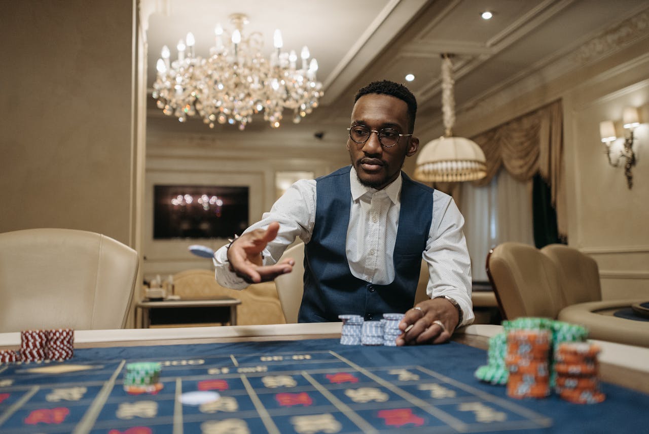Crafting Captivating Headlines: Your awesome post title goes here A man in formal attire plays roulette in a luxurious casino under a chandelier.